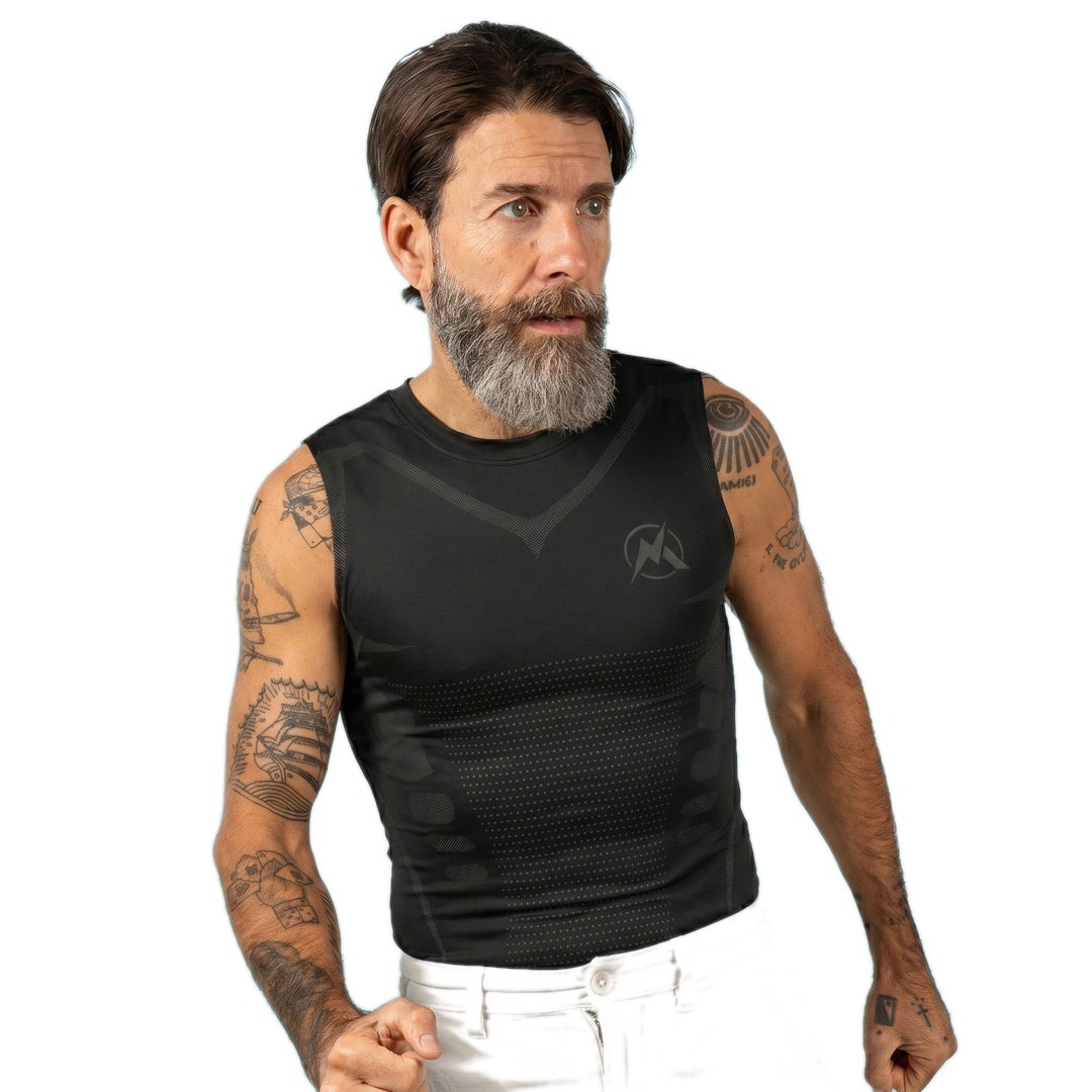 Man wearing the all-black VitaBoost Stealth compression tank on a white background