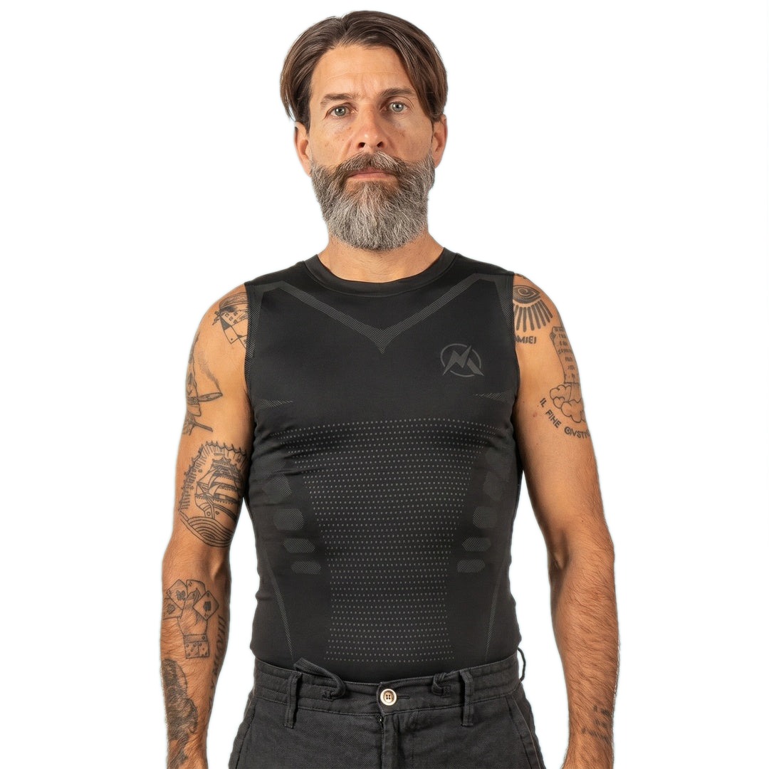 Man wearing the all-black VitaBoost Stealth compression tank on a white background